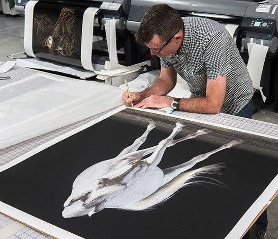 Photographer, Peter Samuels, signing his work